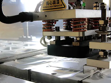 Автоматичне накладання та точне запаювання плівки на лотки